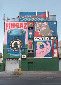 a large building with many colorful signs on it's side and the words fingaz covered all over it