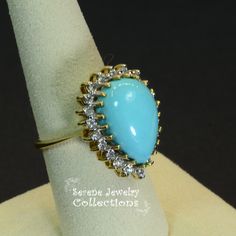 Pretty Levian Sleeping Beauty Turquoise diamond ring, This cabochon is cut in a cute teardrop shape and has a halo of round brilliant diamonds. Ring Size: 7 Total Weight: 8.31 grams Precious Metal: 14k yellow gold Precious stones: -Sleeping Beauty Turquoise Center Stone: 17mmx11.5mm, 13.8 carats -White Round Diamonds: 0.63 carats Hallmark: Levian, 14k Drop Shaped Cabochon Jewelry For Anniversary, Yellow Gold Teardrop Jewelry With Halo Setting, Elegant Turquoise Cabochon Diamond Ring, Oval Diamond Turquoise Ring For Formal Occasions, Yellow Gold Teardrop Halo Jewelry, Formal Turquoise Diamond Ring With Gemstone, Teardrop Center Stone Jewelry, Formal Fine Jewelry Turquoise Diamond Ring, Elegant Turquoise Teardrop Ring For Anniversary