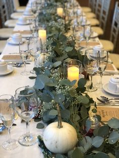 a long table is set with candles and greenery for an elegant fall wedding reception