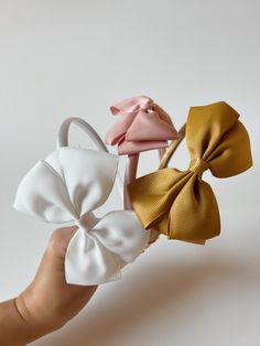 These headband bows are timeless and comfortable for babies and toddlers. They come in three colors. Adjustable White Bow Tie With Decorative Bow, Adjustable Detachable White Bow, Adjustable White Satin Bow Tie, Adjustable White Satin Bow, Playful Adjustable Bow Headband, Playful Bow Headband Hair Accessory, Adjustable Summer Headband With Satin Bow, Adjustable Playful Bow For Summer, Playful Adjustable Bow For Summer