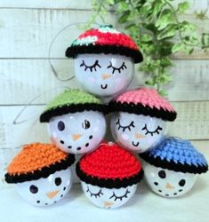 a group of crocheted snowmen sitting next to each other on top of a table