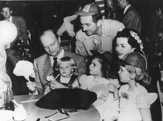 an old black and white photo of people at a party