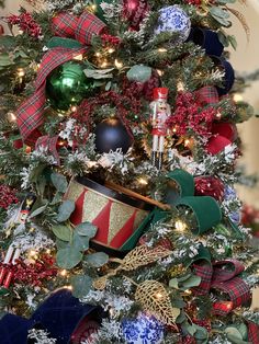 a christmas tree decorated with red, green and blue ornaments