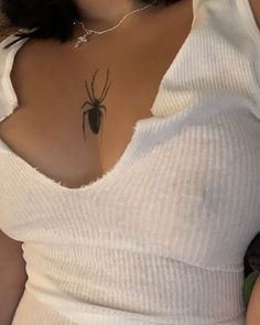 a woman with a spider tattoo on her chest