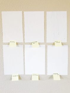 four pieces of white paper with sticky notes attached to them