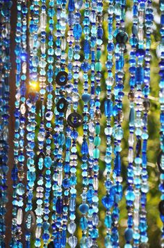 blue beads hanging from the side of a window