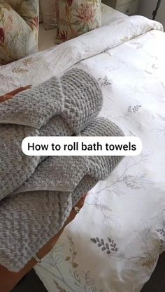 an unmade bed with towels on it and the words how to roll bath towels