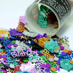 birthday confetti spilling out of a bottle onto the ground