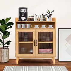 a wooden cabinet filled with cups and mugs next to a potted plant