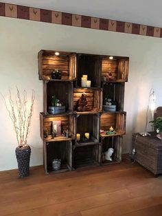 a room filled with lots of wooden boxes and candles on top of it's shelves