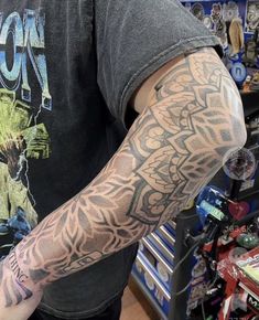 a man with a tattoo on his arm in a store