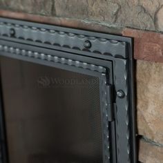 a close up view of a brick wall with a black metal frame on the side