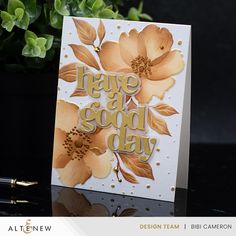 there is a card that says have a good day with flowers and leaves on it