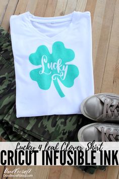 a t - shirt with the words lucky on it next to some shoes and a pair of sneakers