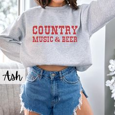 Country Music and Beer Sweatshirt, Beer Shirt, Country Sweatshirt, Western Crewneck, Country Music, Rodeo Shirt, Cowgirl Sweatshirt, Cowboy, Drinking Sweater, Trendy Sweatshirt, Graphic Sweatshirt -Gildan 18000 Crewneck Sweatshirts -Unisex Adult Sizing -Props used in photos are NOT included -Different colors are available for different designs -50% cotton, 50% polyester -Medium-heavy fabric (8.0 oz/yd² (271.25 g/m -Loose fit -Sewn-in label -Runs true to size PRINT: -Direct to garment -The design Fall Music-themed Cotton Tops, Music-themed Cotton Crew Neck Top, Music-themed Cotton Tops With Crew Neck, Music-themed Long Sleeve Cotton Top, Music-themed Cotton Long Sleeve Top, Relaxed Fit Music-themed Crew Neck Top, Cotton Letter Print Sweatshirt For Concert, Music-themed Slogan Crew Neck Top, Music-themed Slogan Tops With Crew Neck