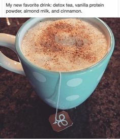 a cup of coffee with cinnamon sprinkles on the side and a tag attached to it