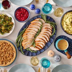 a table topped with plates and bowls filled with food