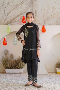 Ready to wear Pakistani girls Formal 3 pc suit. Item Details: Top: Black Chiffon with Hand Adda Work, Embroidery and Malai Crepe Lining Trouser: Black Raw Silk Pants with Embroidery Dupatta: Black Chiffon Dupatta with Gota Laces Feel free to ask about the measurements. We are happy to help you. Thank you.. * As it is handmade, some stones or threads may be pulled off. We really do take great care of our clothes while shipping. Thank you.. **All sales are FINAL.. No returns or exchanges... To see Pakistani Kids Dresses, Black Chiffon Shirt, Embroidery Dupatta, Eastern Dresses, Kids Party Wear Dresses, Kids Party Wear, Dresses Sewing, Partywear Dresses, Fancy Kurti