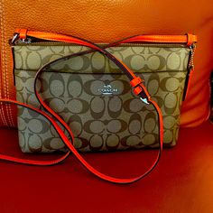 New Gift Never Used. Rich Classic Brown With Orange Strap 11’x 7’ Long Adjustable Strap. Orange Zipper Closure Crossbody Shoulder Bag, Orange Shoulder Bag With Zipper For Shopping, Orange Shoulder Bag For Shopping With Zipper, Orange Pouch Bag For On-the-go, Orange Bag With Adjustable Strap For Errands, Orange Bag With Removable Pouch For Errands, Orange Shoulder Bag With Removable Pouch, Orange Travel Bag With Zipper Closure, Coach Orange Crossbody Shoulder Bag