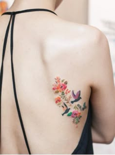 the back of a woman's shoulder with flowers on it