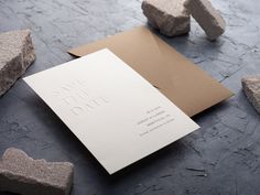 a card with the words save the date written on it next to some small rocks