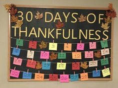 a bulletin board that says 30 days of thanksgiving written on it with colorful notes and leaves