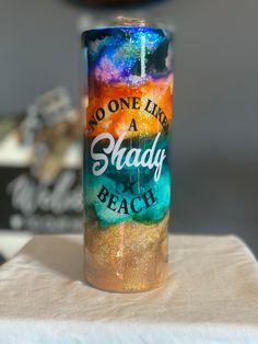 there is a candle that has been painted with words on it and the word, no one like a shady beach