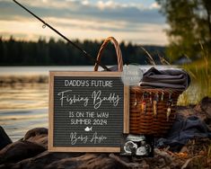 a sign that says daddy's future fishing buddy is on the way