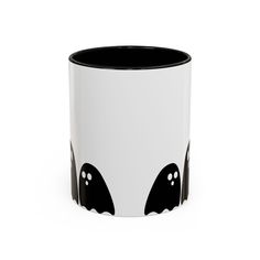 a black and white mug with two bats on it