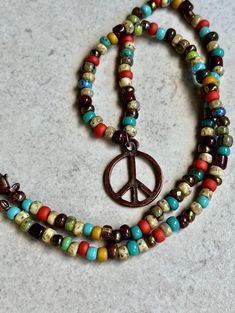 small bead multicolor boho necklace   seed bead necklace   peace sign pendant necklace * multicolor Czech glass seed beads - 4mm * antiqued copper plated peace sign pendant - 19mm * antiqued copper plated lobster clasp * necklace length from end to end - 17mm, pendant drops 7/8"   * you can enter my shop here: gypsydangles.etsy.com Bohemian Beaded Necklace With Lobster Clasp, Bohemian Peace Sign Necklace For Gift, Nickel Free Multicolor Bohemian Beaded Necklaces, Adjustable Multicolor Charm Necklaces Nickel Free, Bohemian Multicolor Nickel-free Beaded Necklaces, Adjustable Multicolor Nickel-free Charm Necklaces, Bohemian Nickel-free Beaded Necklaces, Hippie Multicolor Nickel-free Jewelry, Bohemian Beaded Necklaces With Lobster Clasp