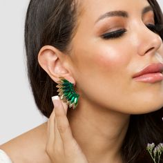 Show off your other worldly sense of style with these Green Gold Small Wing Earrings. Made to look like an angel wing, the statement earrings are adorned with opulent green and gold-toned sequins layered atop one another to form the wings. They are sure to make a chic fashion statement at any party or outing. Size: Length: 2''/ Width: 1'' Look Like An Angel, Other Worldly, Small Wing, Butterfly Wing Earrings, Fall 23, Angel Wing Earrings, Winter Inspired, Prom Earrings, Wing Earrings