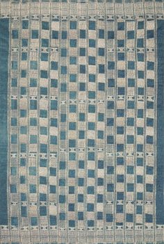 a blue and white rug with squares on it