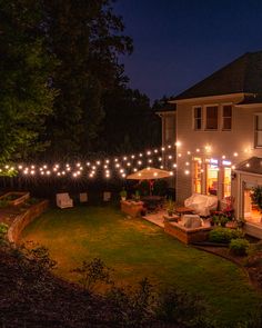 an outdoor patio is lit up with string lights