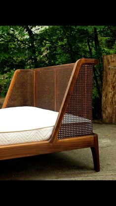 a bed that is made out of wood and wicker