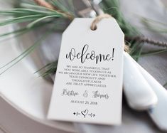 a white plate topped with a green leafy place card next to a fork and knife