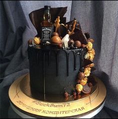 a chocolate cake decorated with candies and liquor bottles