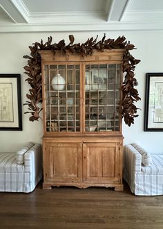 a wooden cabinet sitting in the middle of a living room