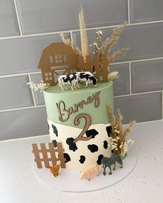 a birthday cake decorated with farm animals and numbers