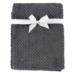 a gray blanket with a white bow on it