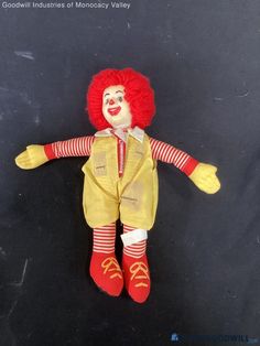 a red haired clown doll laying on the ground