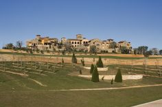 a large house sitting on top of a lush green hillside