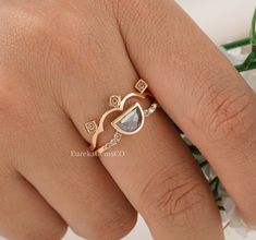 a close up of a person's hand wearing a gold ring with diamonds on it