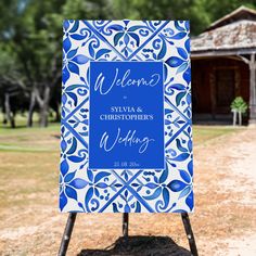 a blue and white sign sitting on top of a dirt field