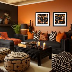 an orange and black living room with zebra print pillows on the couches, ottomans and coffee table