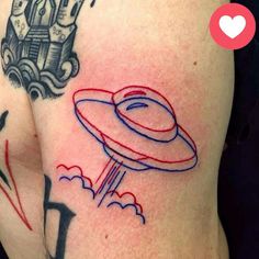 a tattoo on the back of a woman's shoulder with an image of a flying saucer