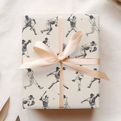 a gift wrapped in wrapping paper with baseballs on it