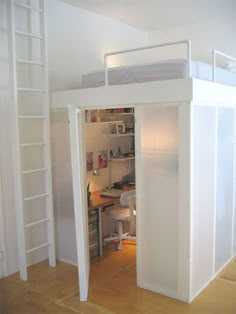 there is a loft bed with a desk and ladder to the top floor in this room