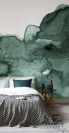 a bedroom with green watercolor paint on the wall