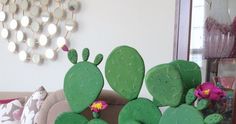 a green cactus plant sitting on top of a couch