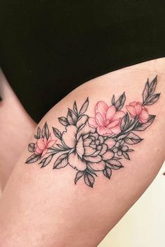 a woman's thigh with flowers and leaves on it